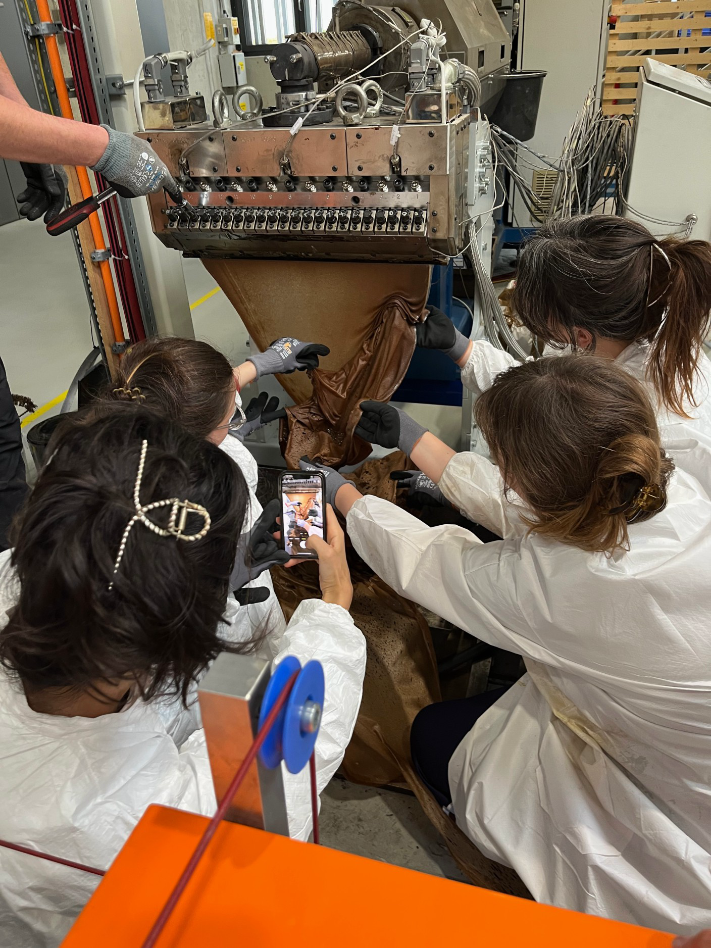 Hands shaping a material. Mealworm frass bound for the first time with a bio-PLA. A workshop by Yana Zschiedrich in collaboration with the research cluster MERGE. Participants: Brigita Kasperaite, Corinna Wolff, Taisiia Kravchenko, and Olena Melnyk.